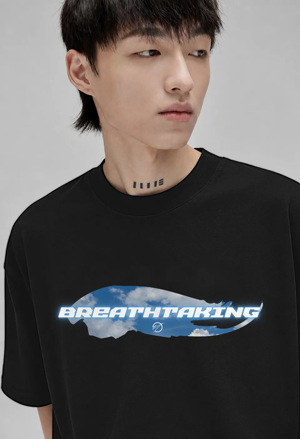 Close-up of the sky-blue cloud Breathtaking banner on a black oversized t-shirt