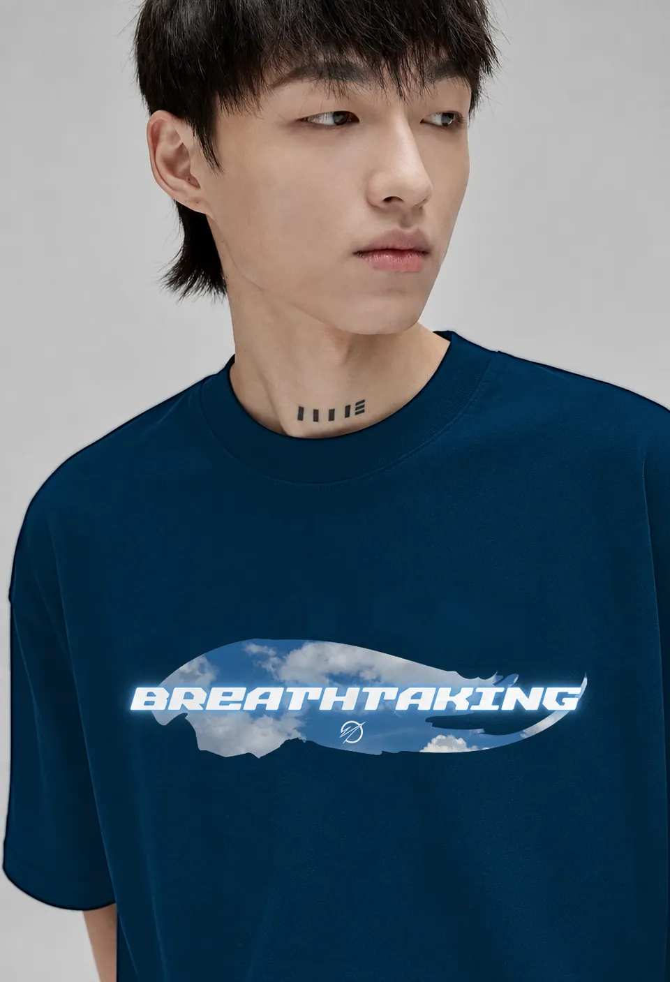 Close-up of the sky-blue cloud Breathtaking banner on a navy blue oversized t-shirt