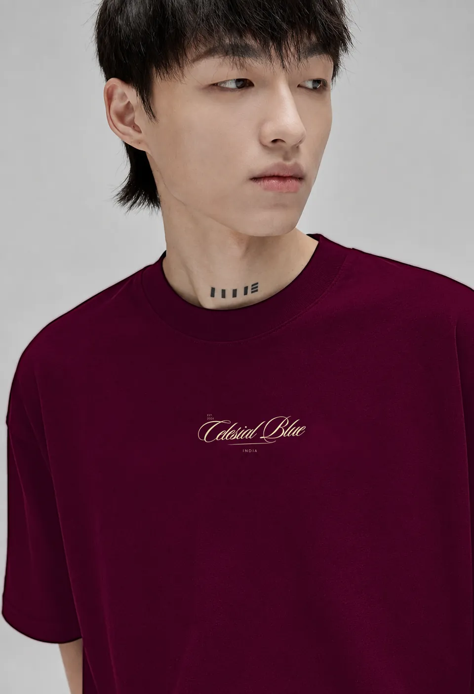 Close-up of the cream Celesial Blue script on the burgundy Classic t-shirt