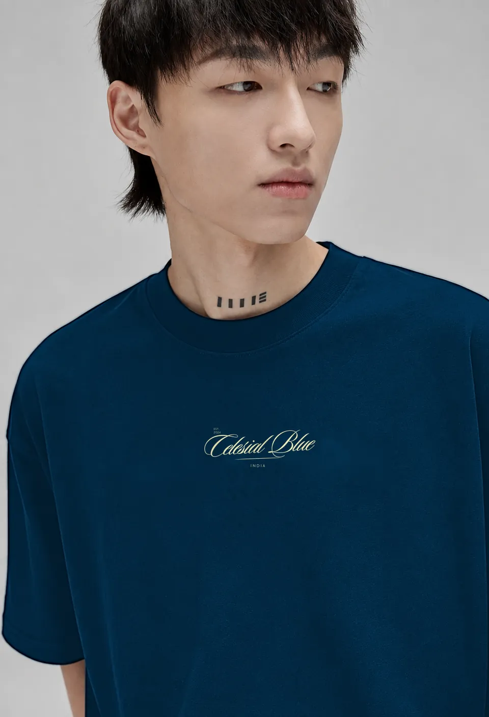 Close-up of the cream Celesial Blue script on the navy blue Classic t-shirt