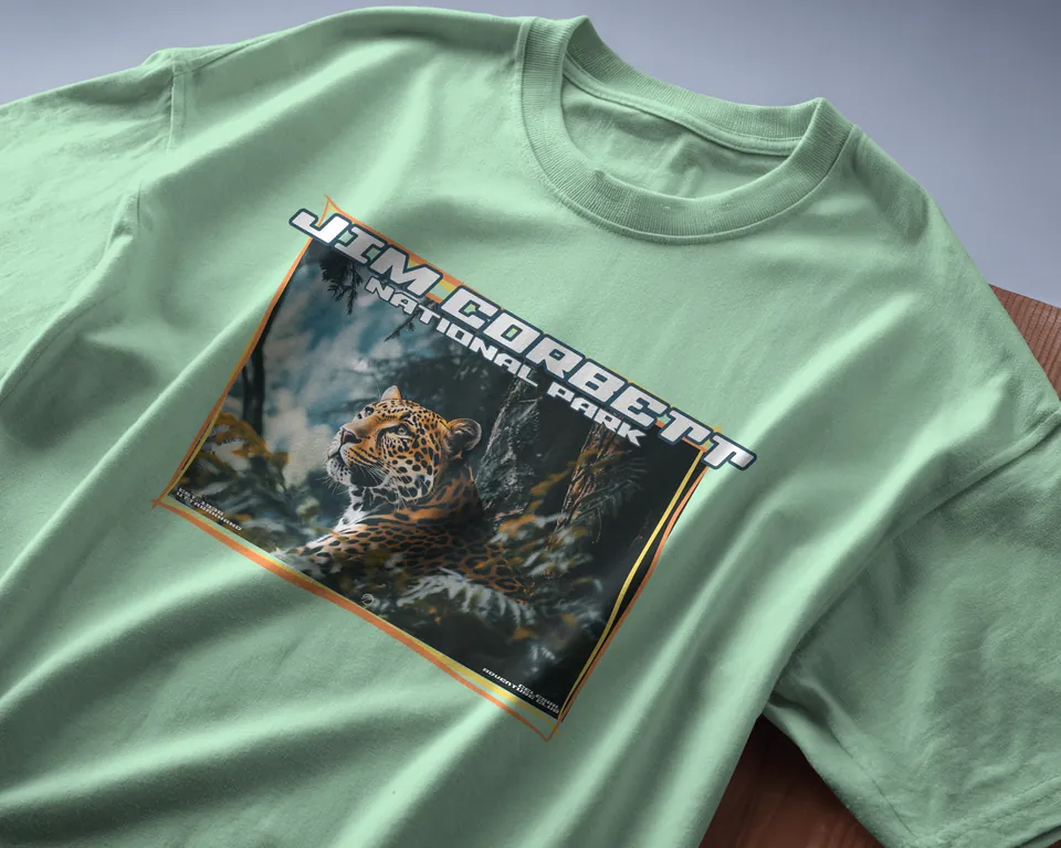 Jade green oversized t-shirt with the Jim Corbett leopard print, angled close-up