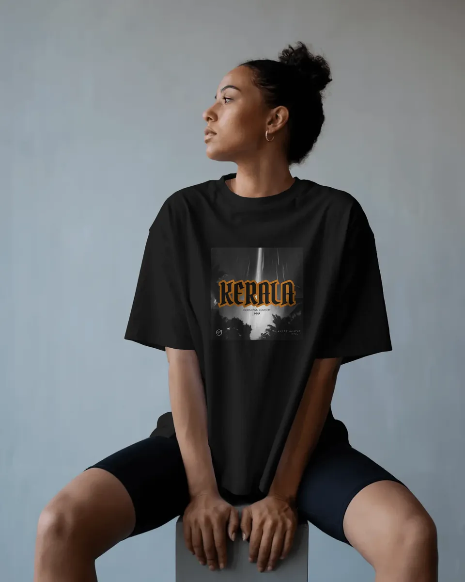 Model wearing the black Kerala oversized t-shirt, seated