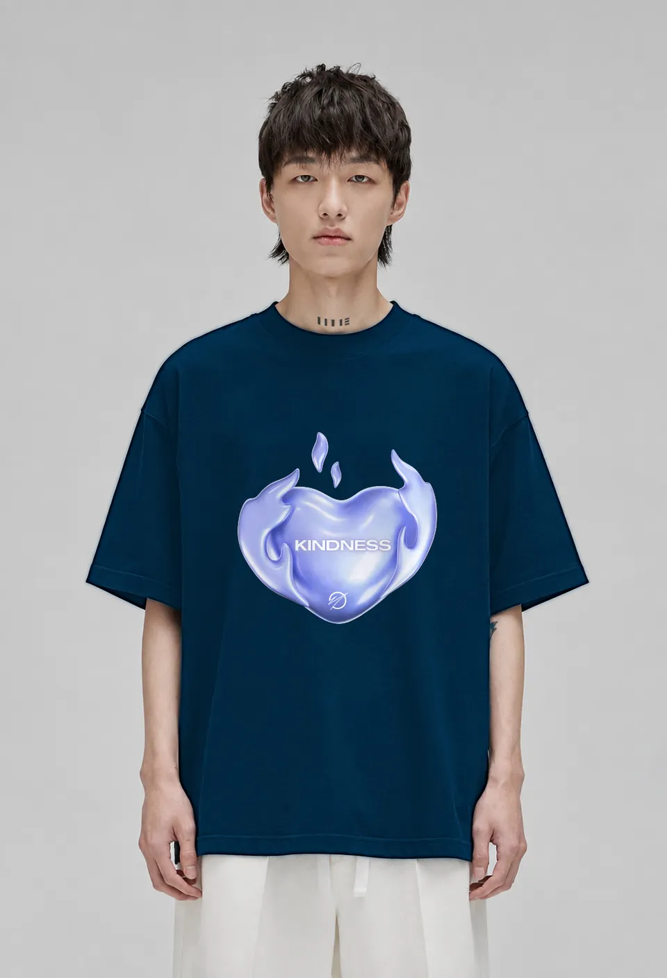 Model wearing the navy blue Kindness oversized t-shirt with the lavender chrome Kindness heart, front view