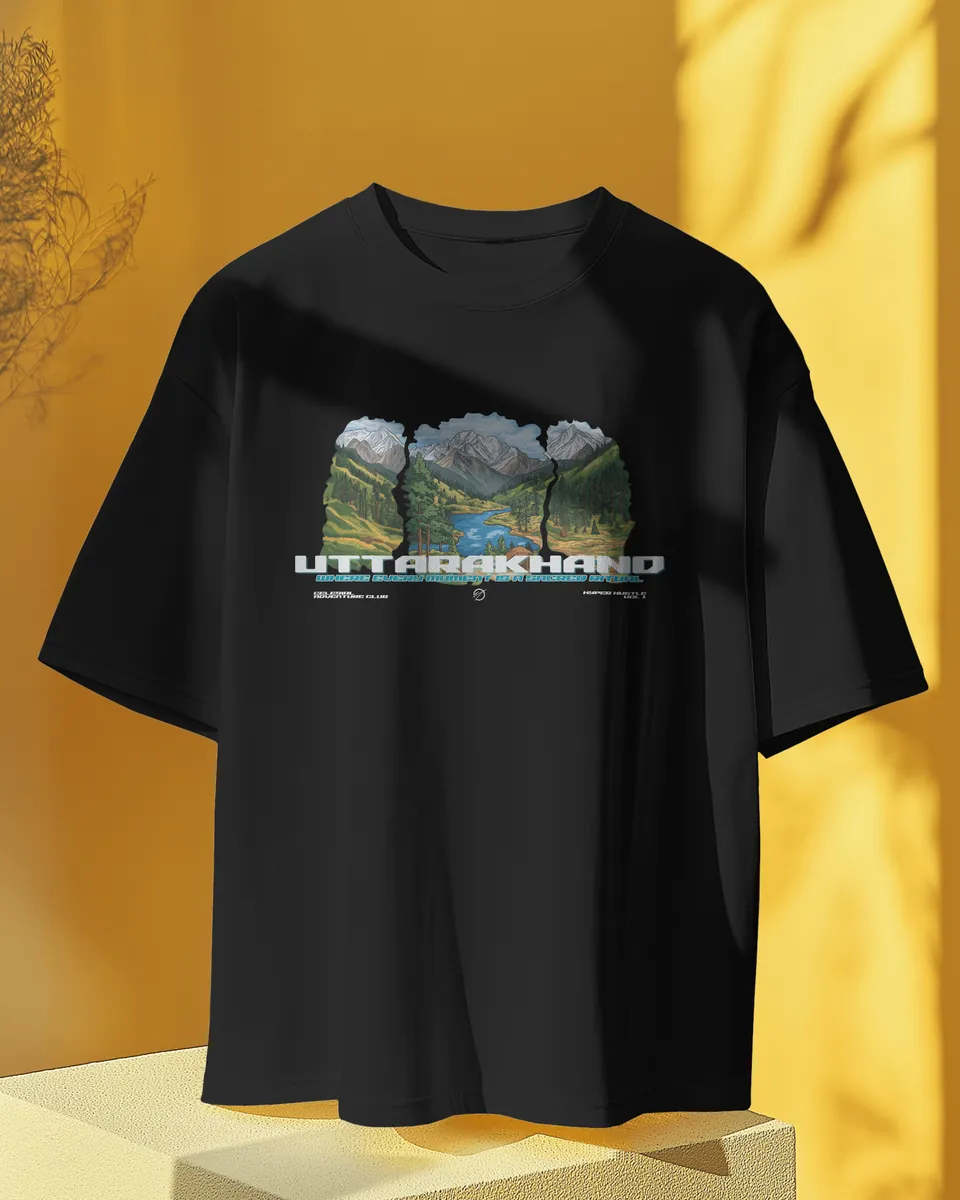Black oversized t-shirt with the Uttarakhand print on a yellow studio stand